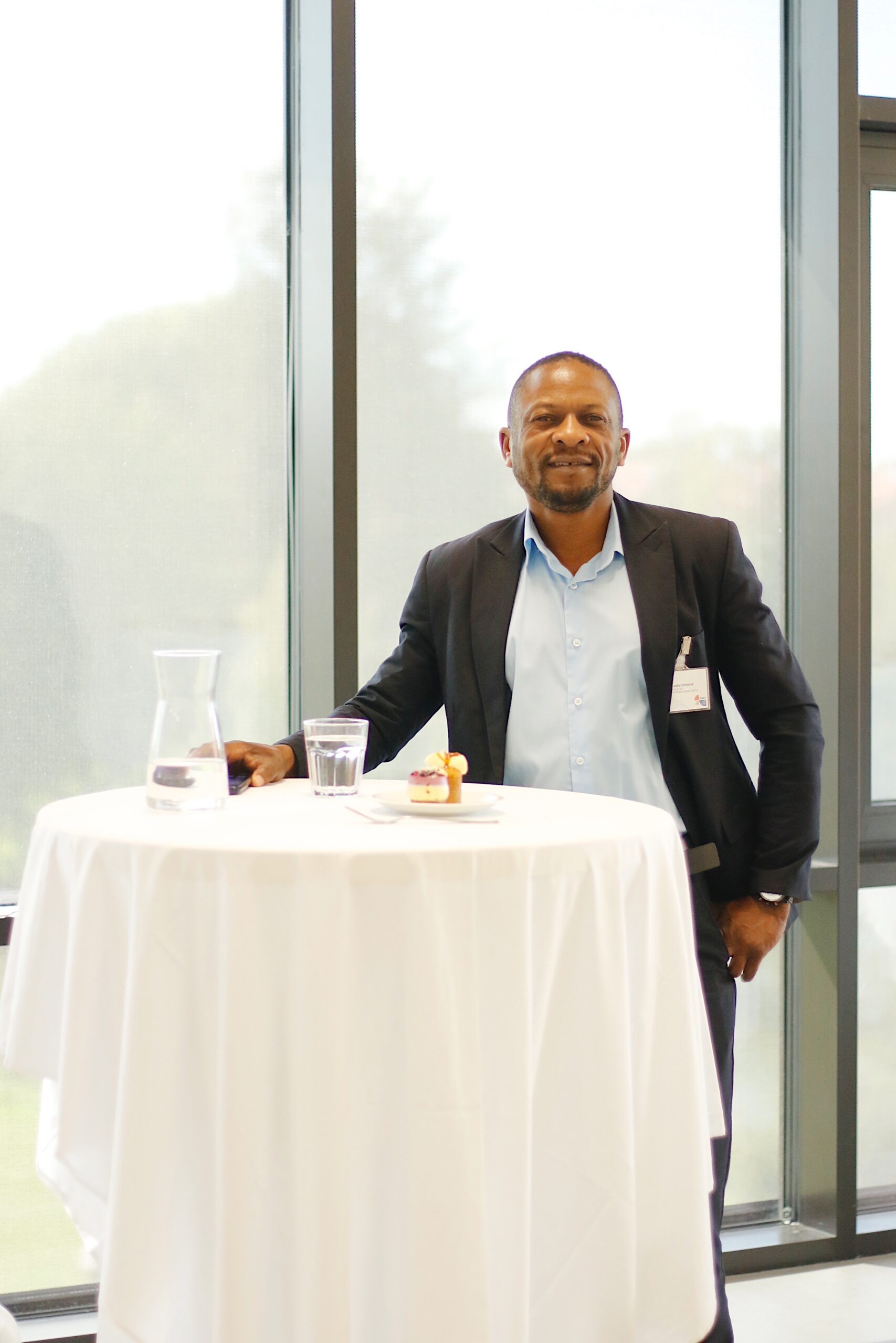ZamNordic representative standing beside a table at a business event